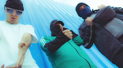 a group of young men sitting on top of a blue tarp