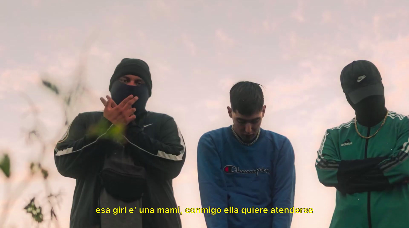 three men standing next to each other in front of a cloudy sky