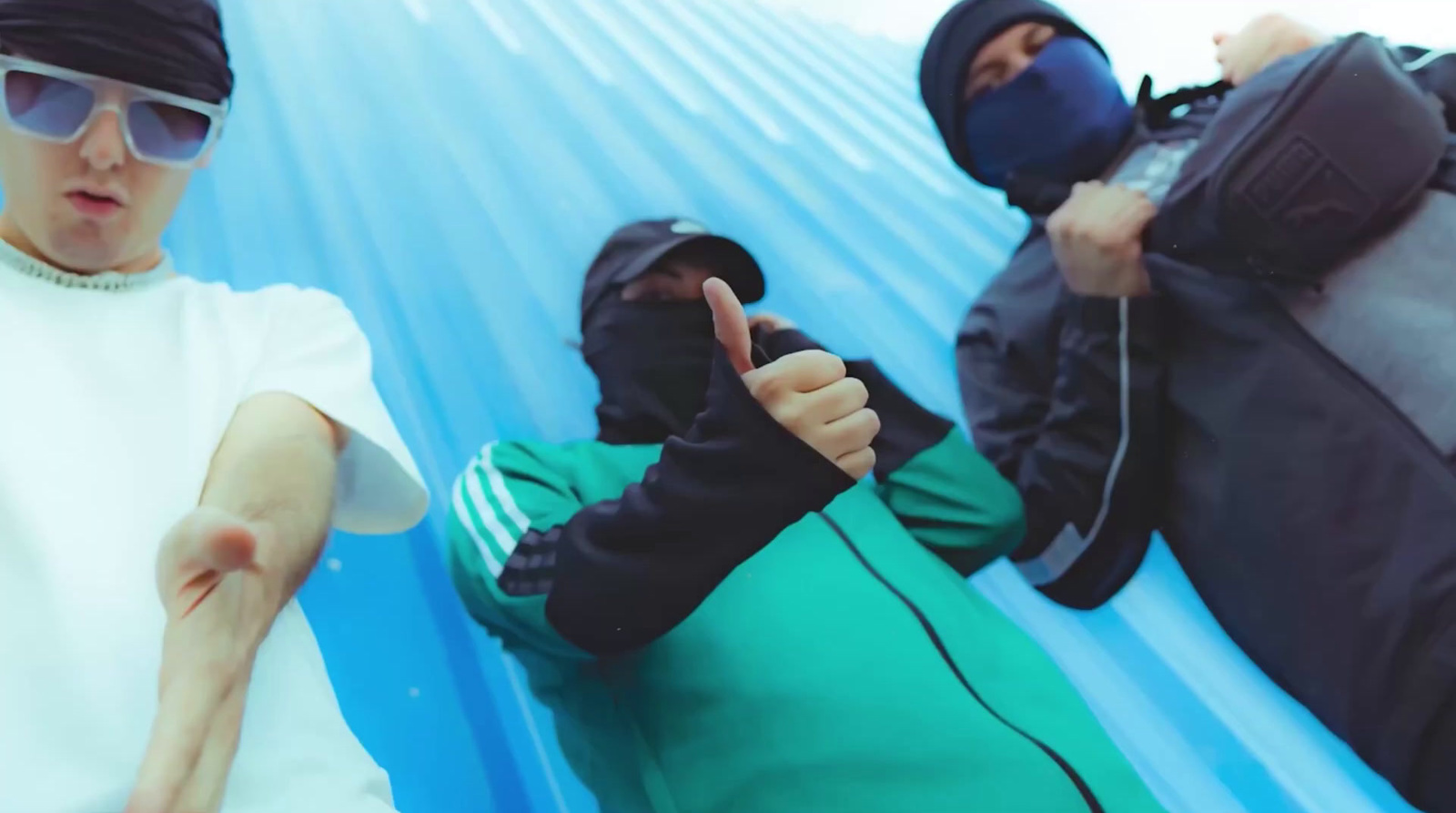 a group of people sitting on top of a blue tarp