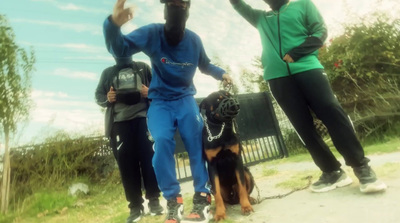 a group of people standing next to a dog