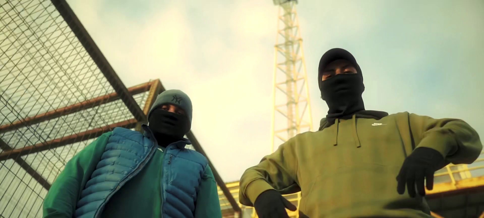 two masked men standing next to each other