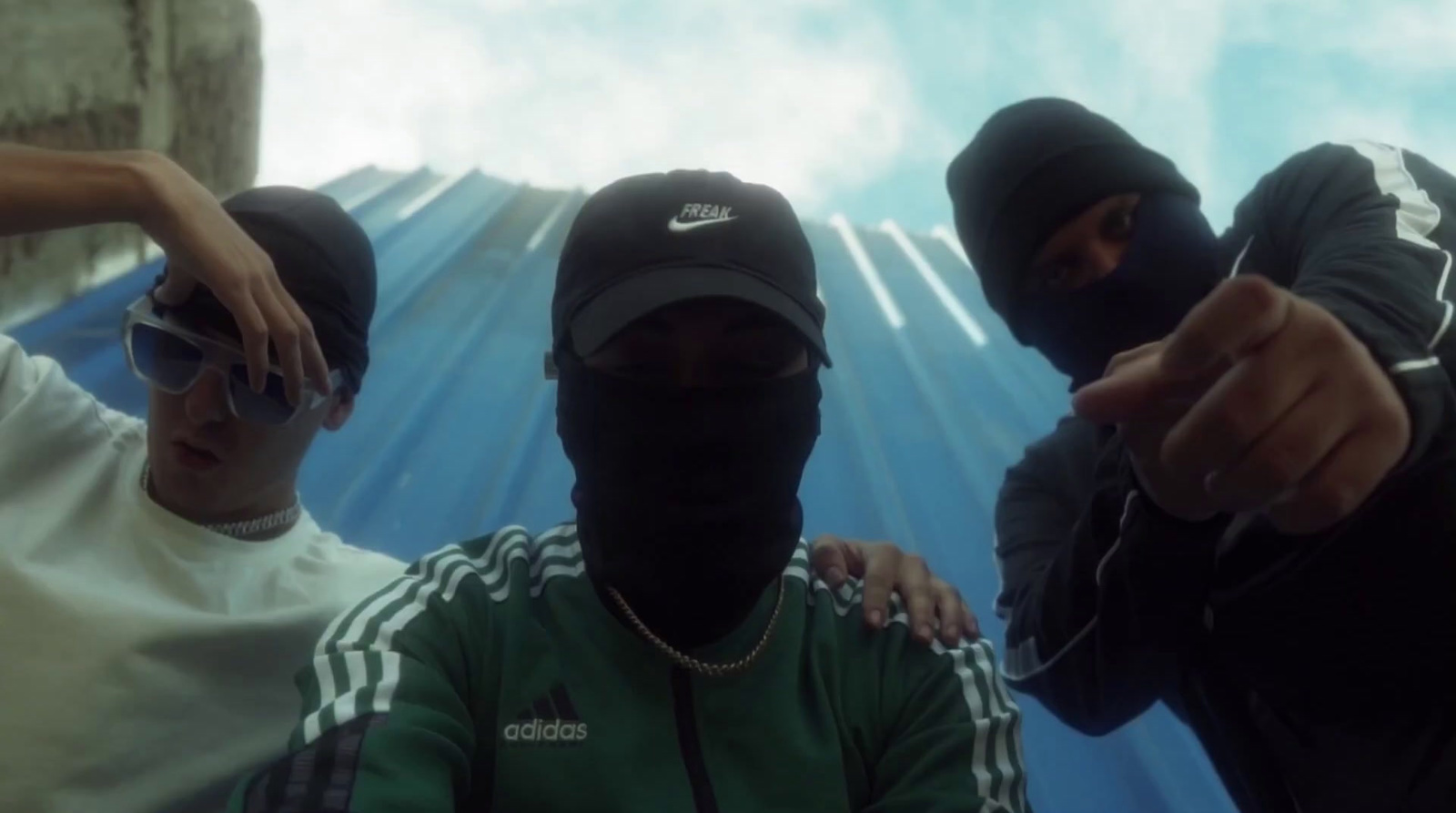 a group of three men wearing face masks