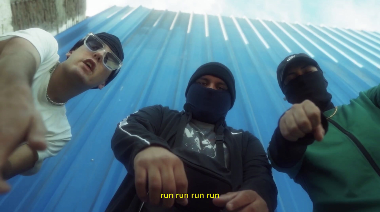 three men wearing masks and pointing at the camera