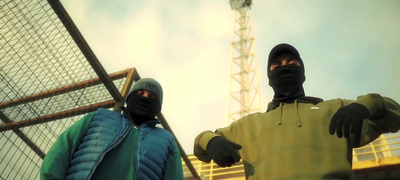 two masked men standing next to each other