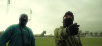 a couple of men standing next to each other on a field