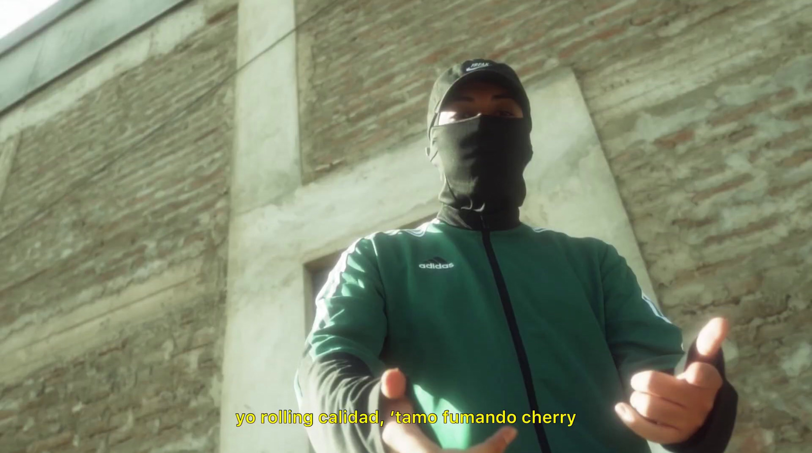 a man wearing a face mask giving a thumbs up