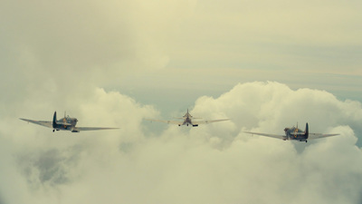 two planes flying in the sky above the clouds