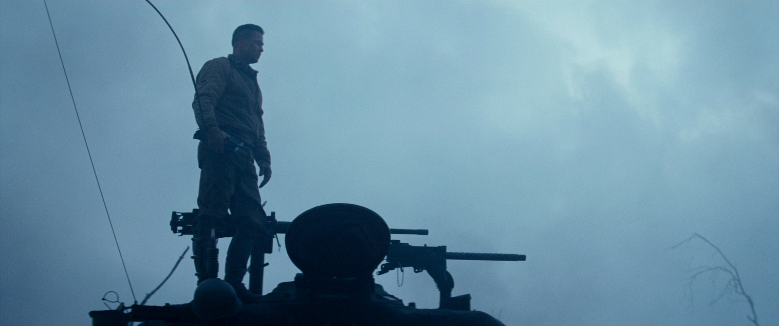 a man standing on top of a machine gun