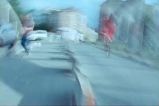 a blurry photo of a person riding a bike down a street