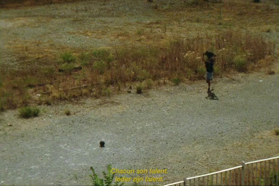 a man riding a skateboard down a dirt road