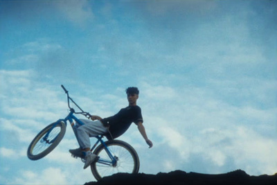 a man riding a bike up the side of a mountain