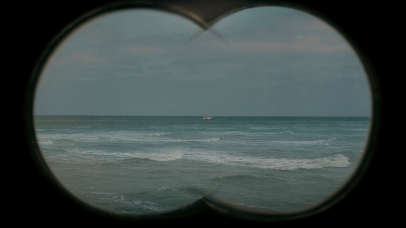 a view of the ocean through a round window