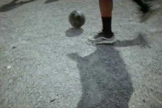 a person standing next to a soccer ball