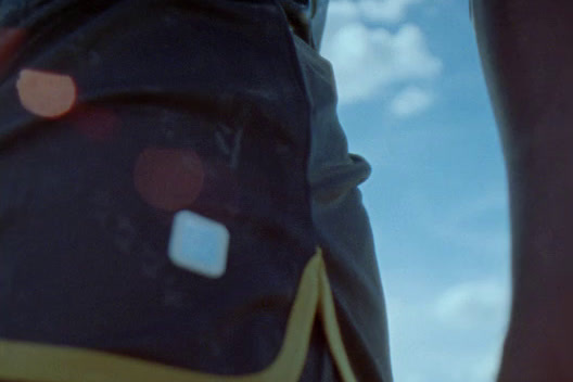 a close up of a person's pants with a sky background