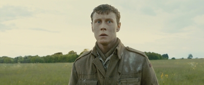 a man standing in a field with a surprised look on his face