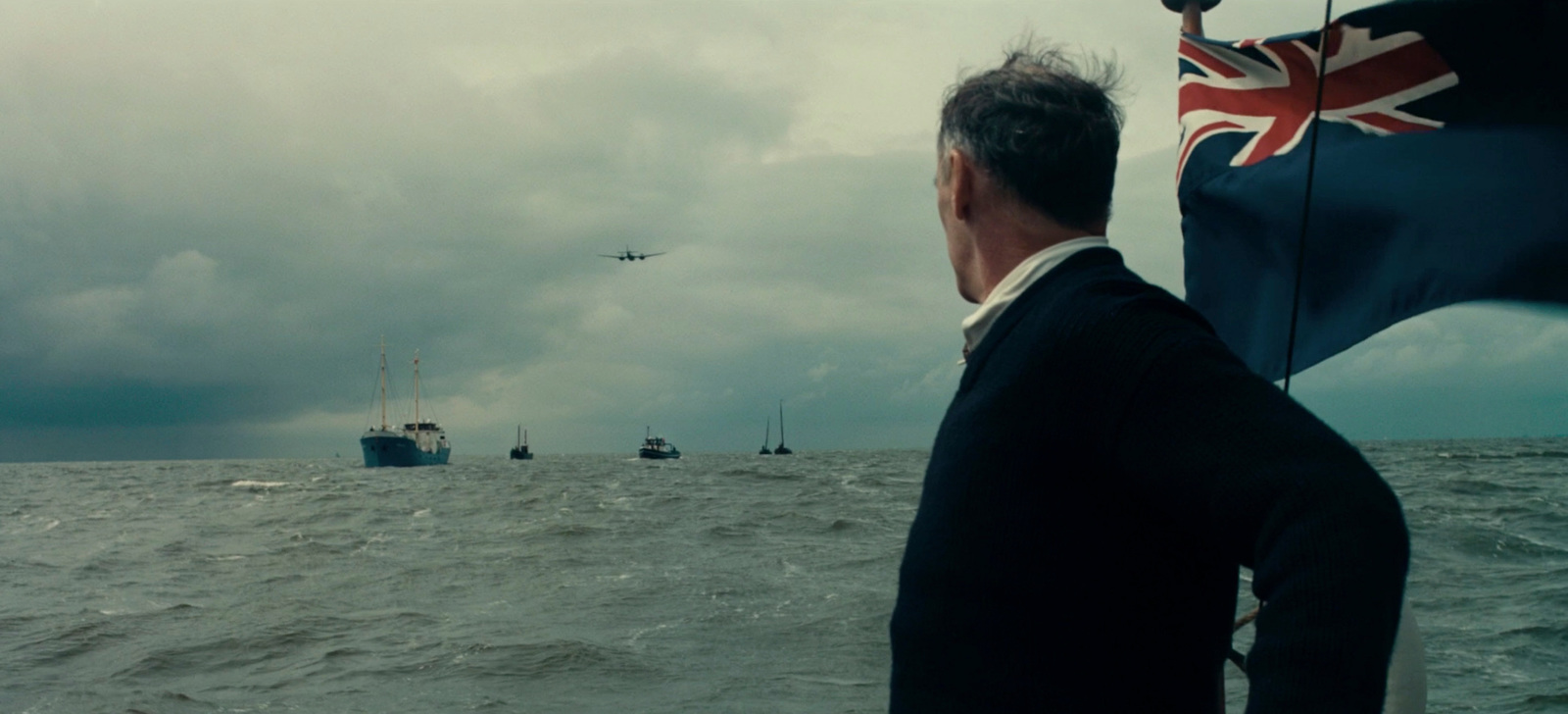 a man standing on a boat looking out at the ocean