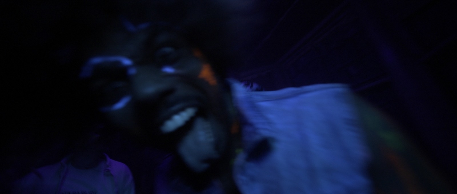 a man with his mouth open in the dark