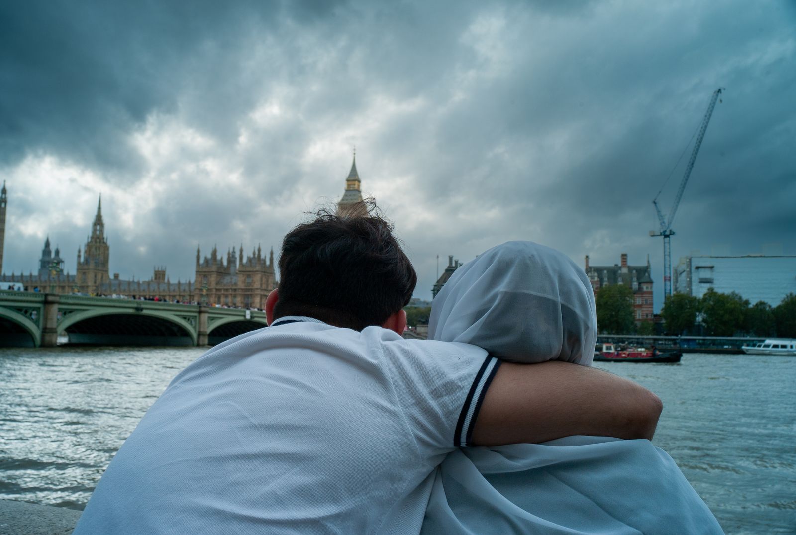 a man and a woman are looking at the water