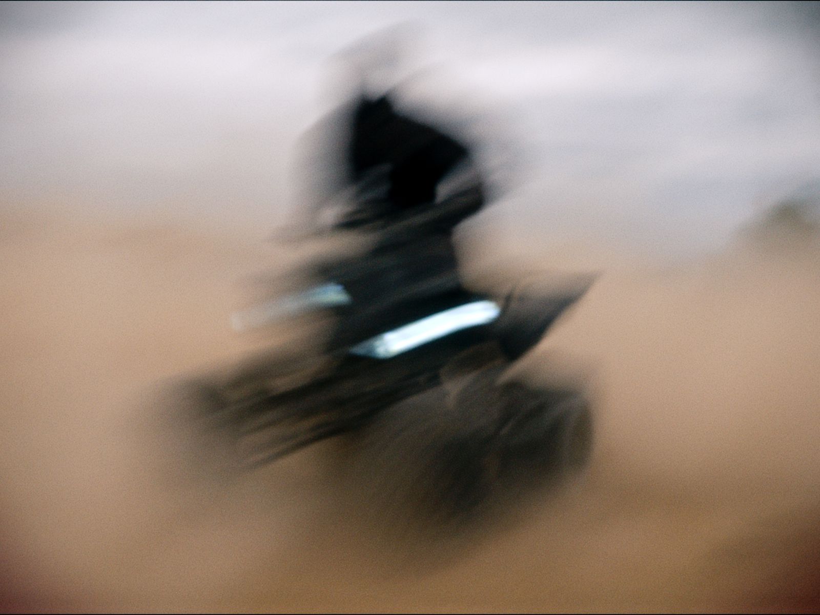 a blurry photo of a person on a motorcycle