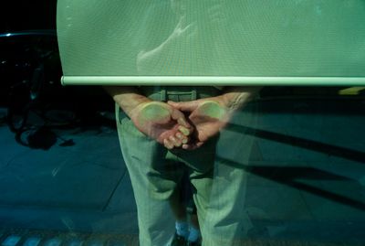 a man holding a laptop behind his back