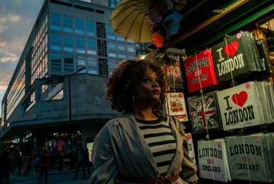 a woman standing in front of a store