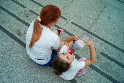 a woman and a child sitting on the ground