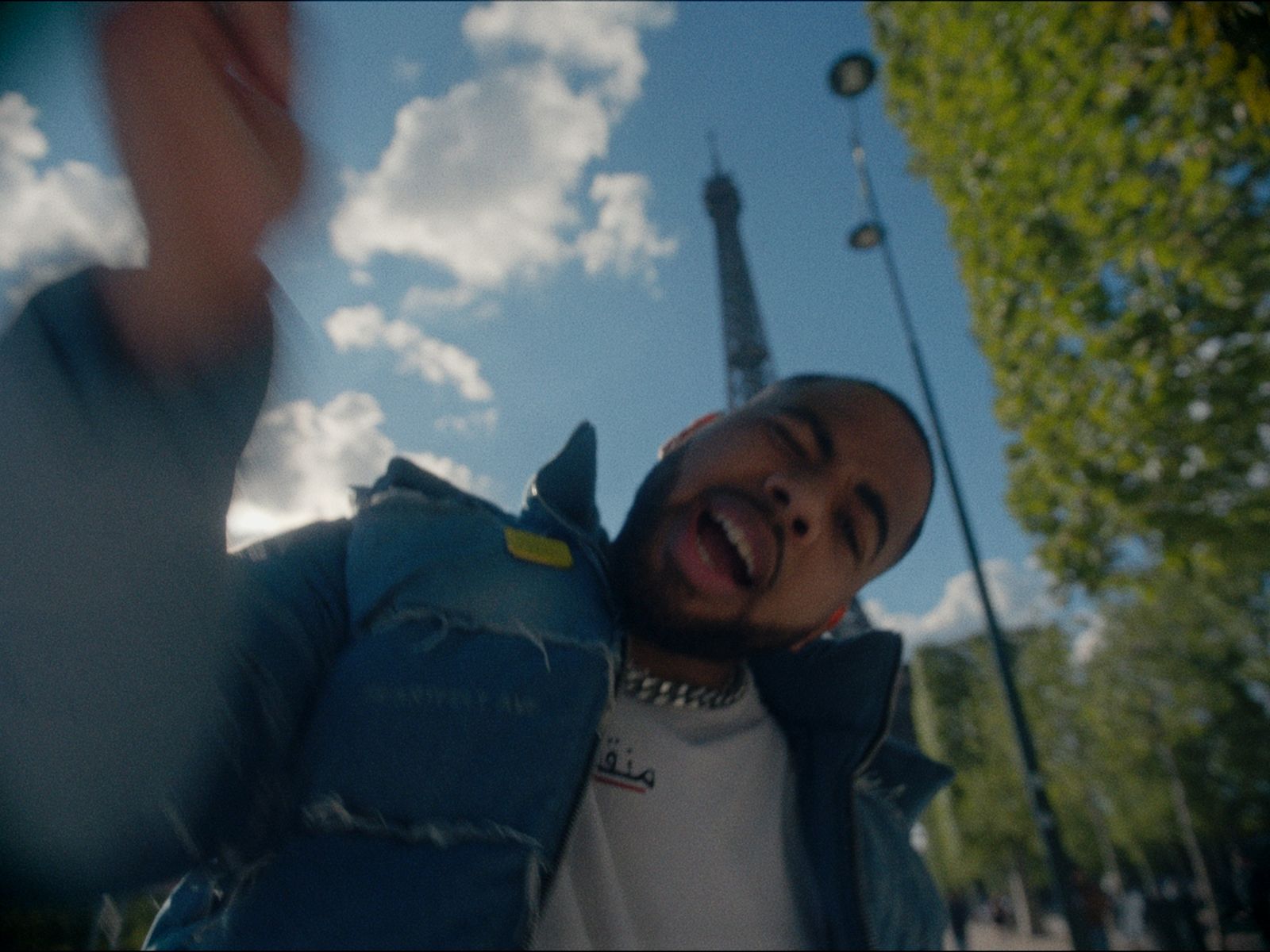 a man taking a selfie in front of the eiffel tower