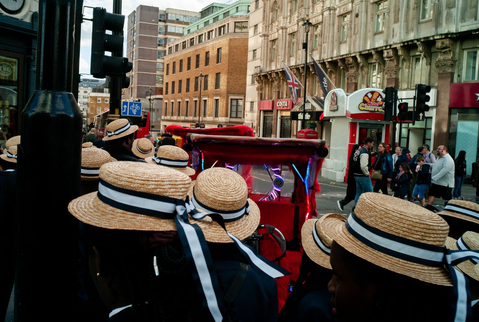 a group of people wearing hats on a city street