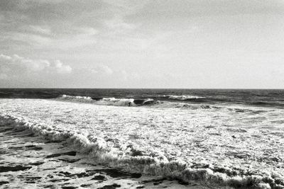 a black and white photo of the ocean waves