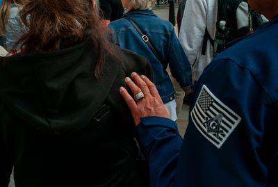 a woman holding a man's hand in a crowd of people