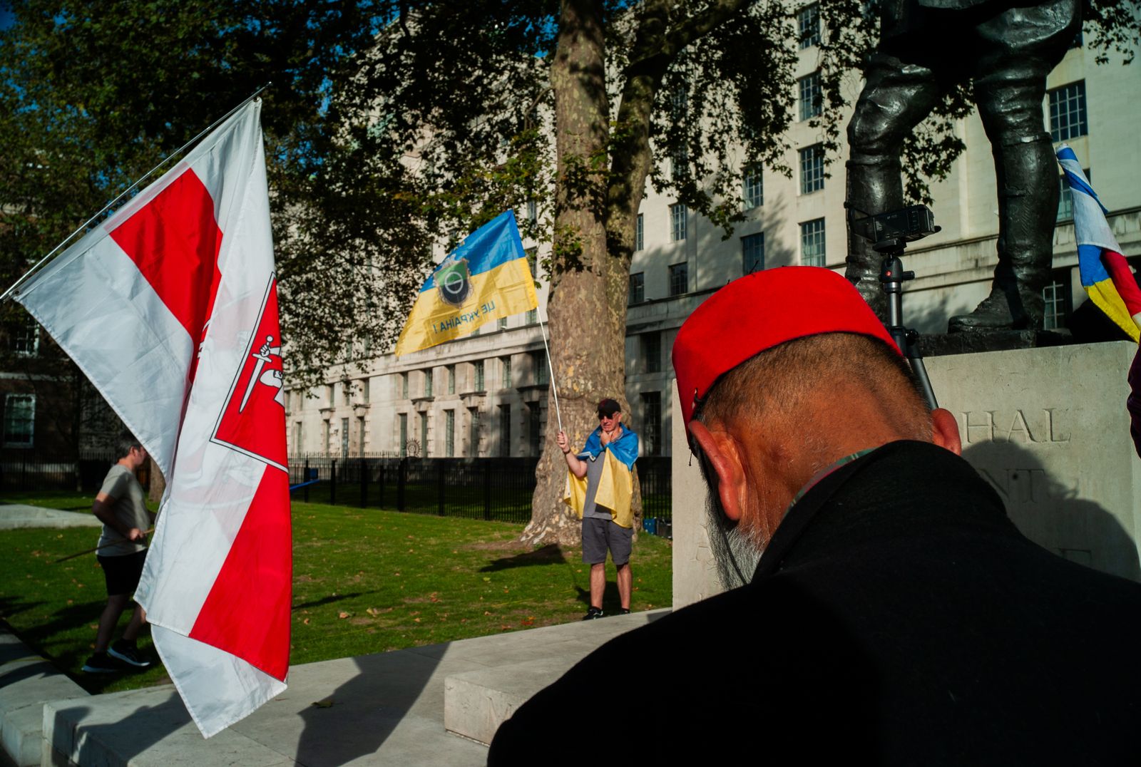 a man in a red hat and a flag