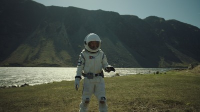 a man in a space suit standing in a field