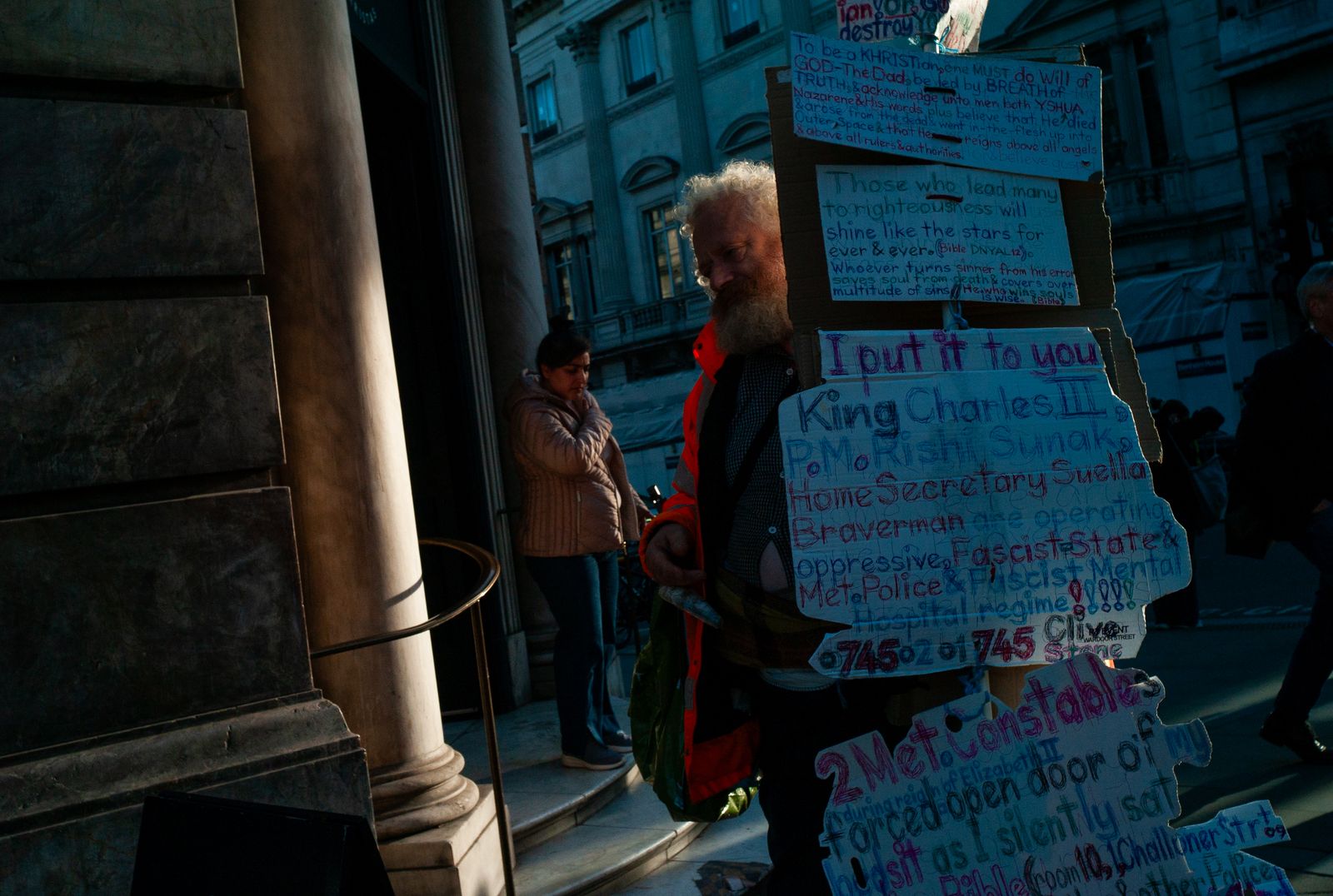 a man standing next to a pile of signs