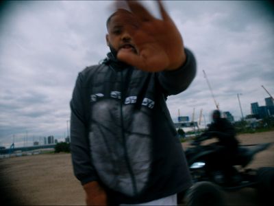 a man standing next to a motorcycle on a beach