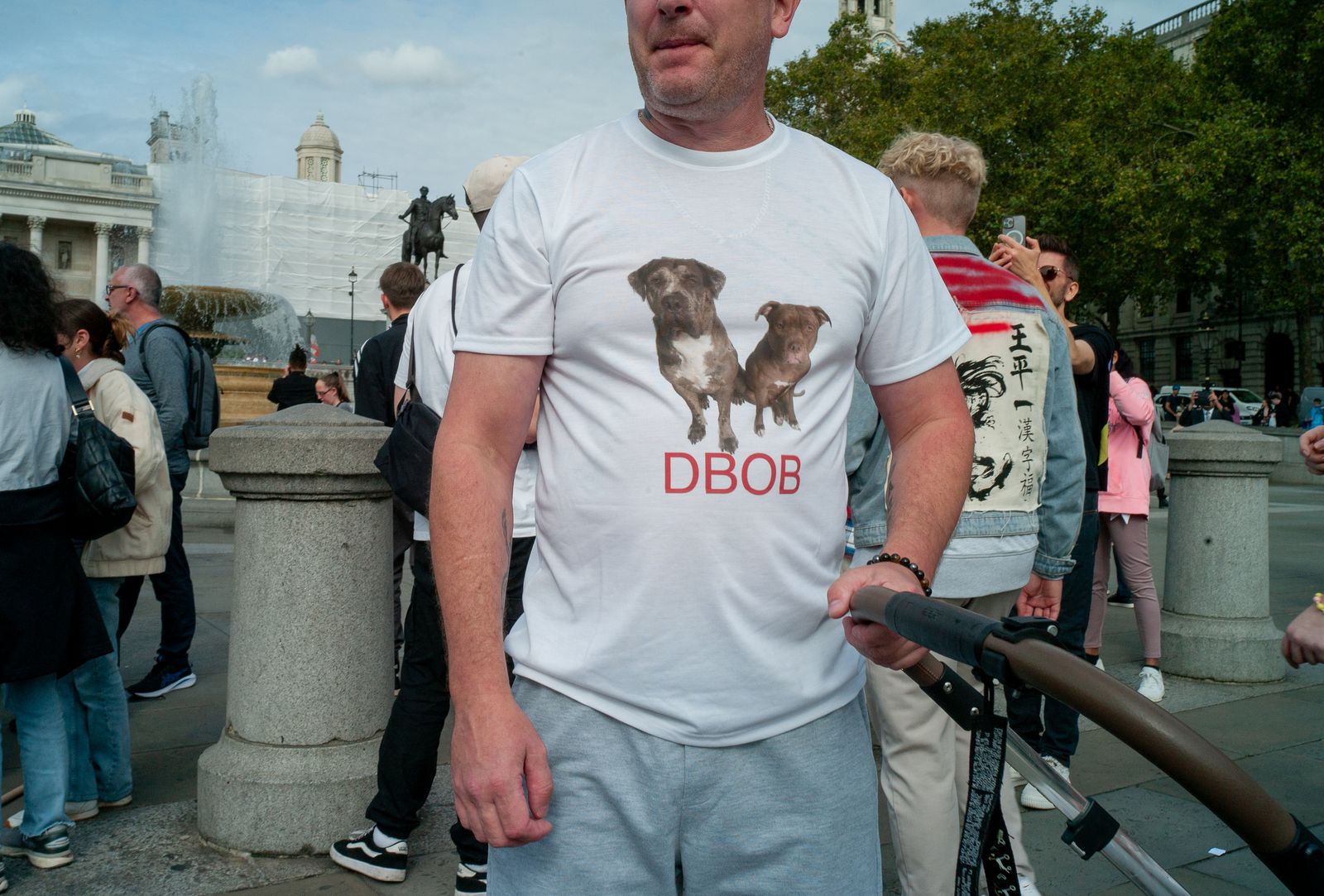 a man standing next to a crowd of people