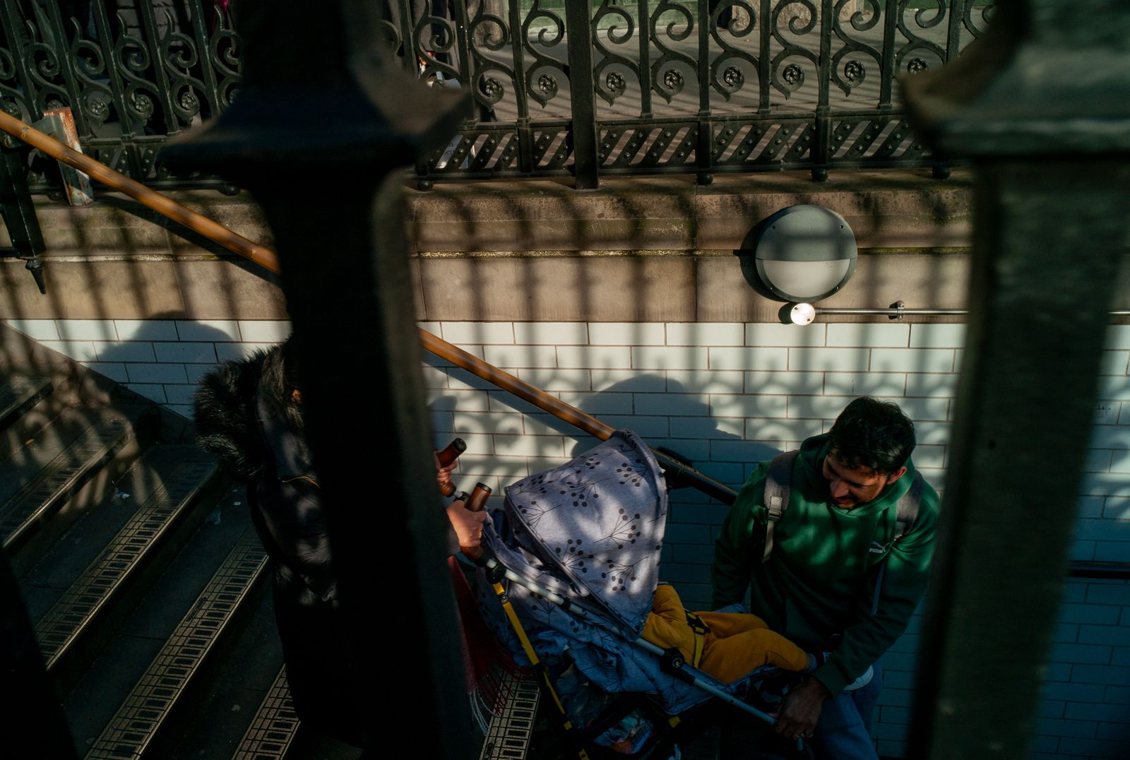 a man standing next to a baby carriage