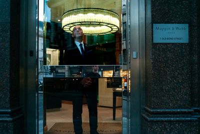 a man in a suit standing in a doorway