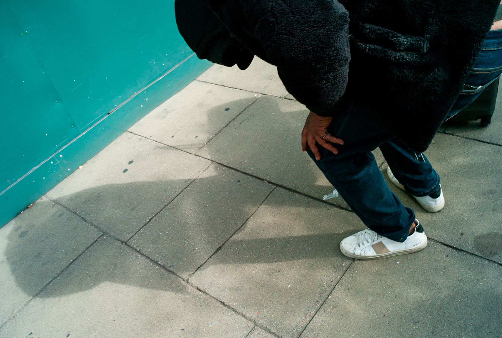 a person in a black bear costume standing on a sidewalk