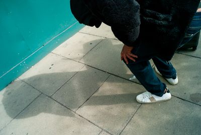 a person in a black bear costume standing on a sidewalk