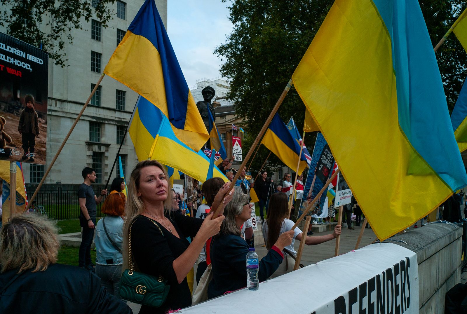 a group of people holding flags on a city street