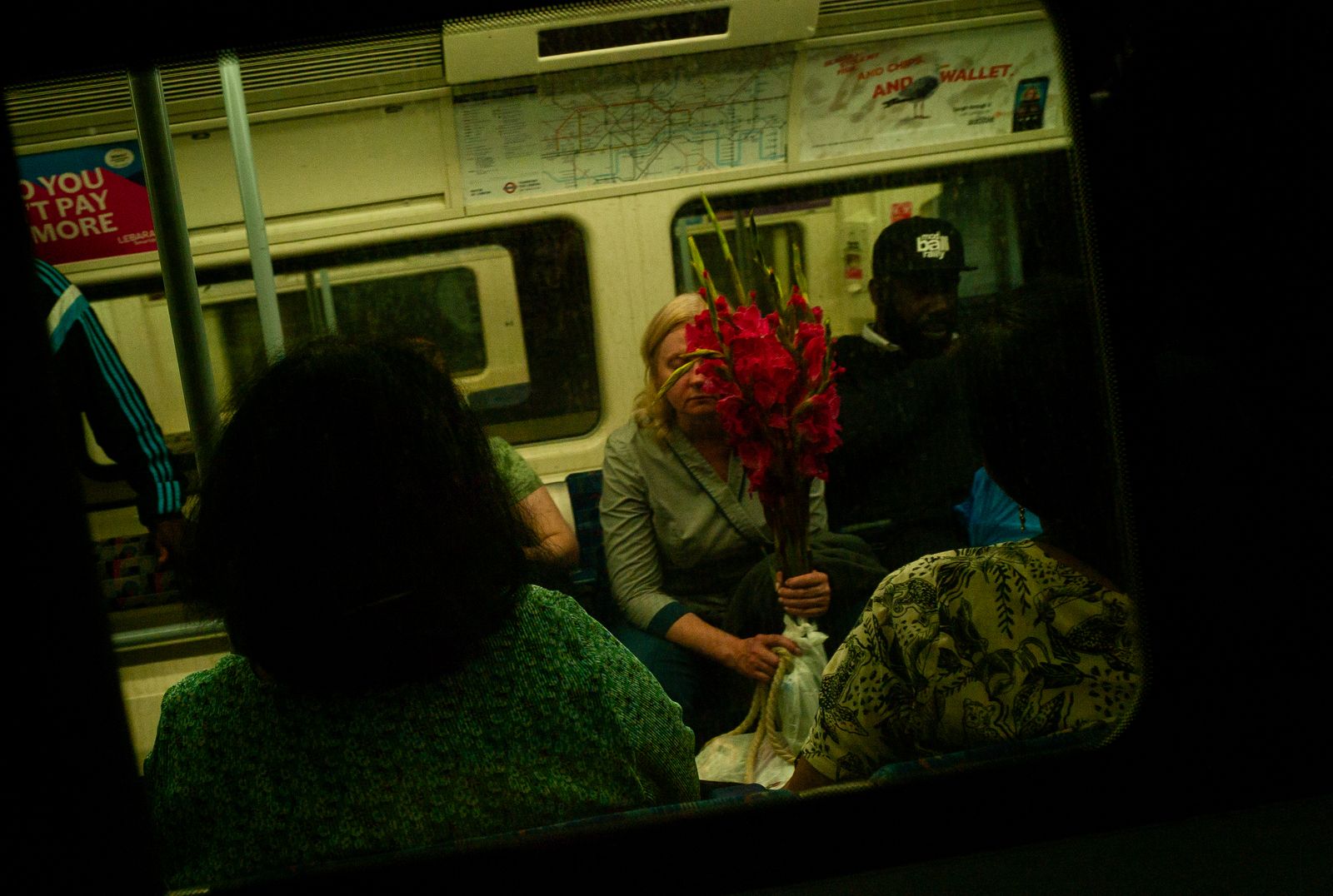 a group of people sitting on a train next to each other