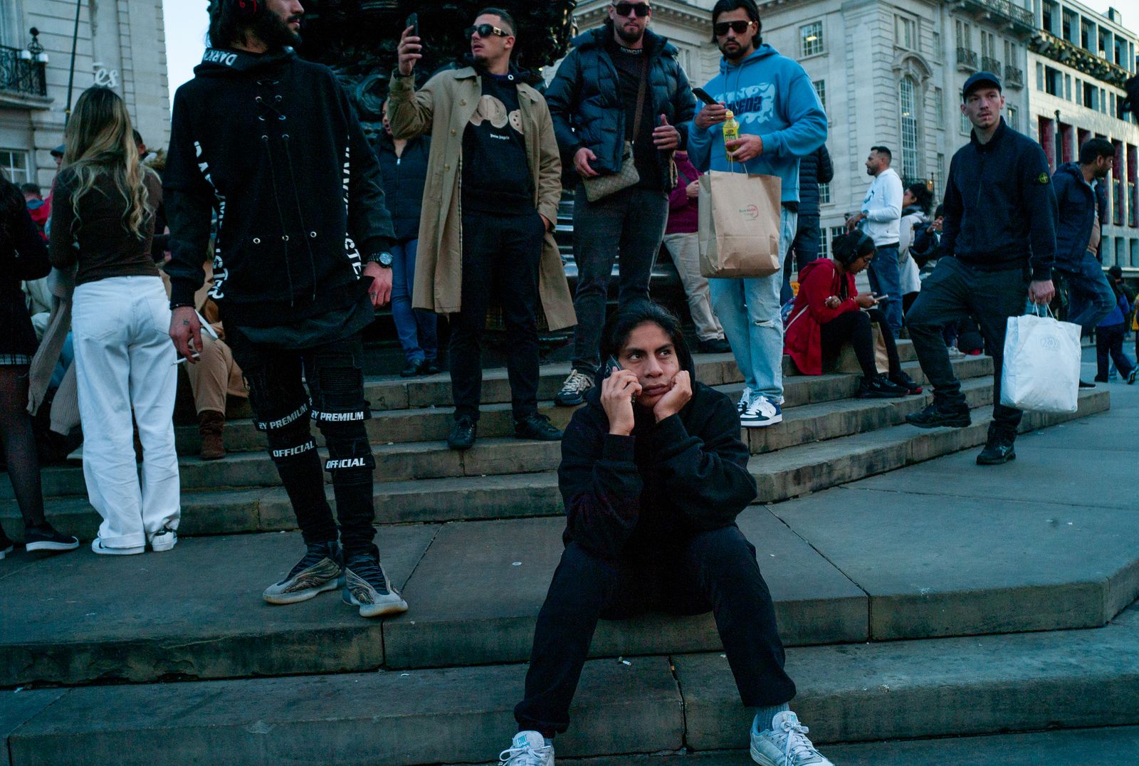 a woman sitting on the steps in front of a group of people