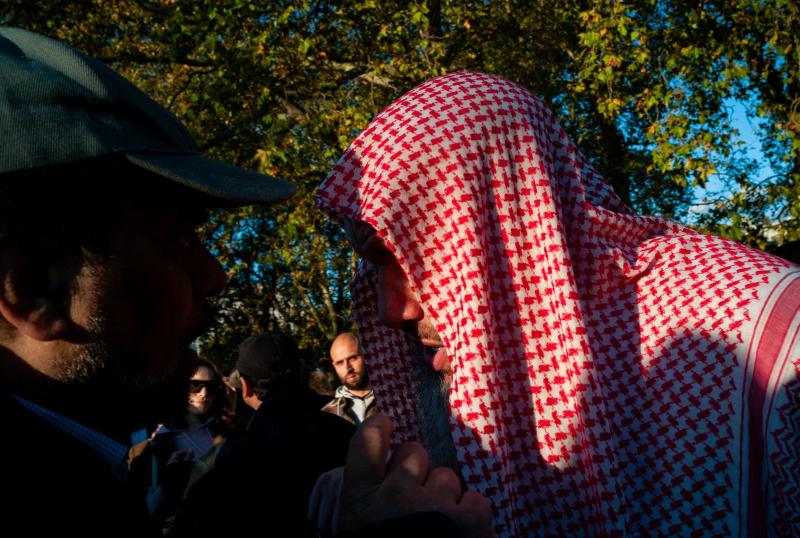 a man wearing a red and white checkered robe