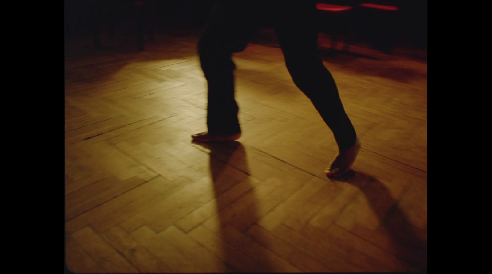 a person standing on top of a wooden floor