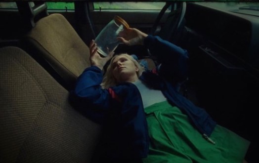 a woman laying in the back of a car