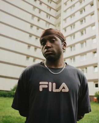 a man standing in front of a tall building