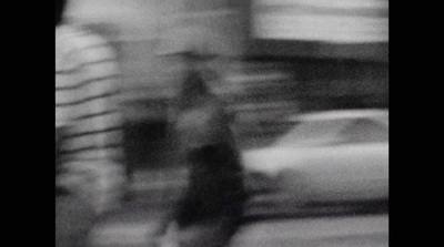 a blurry photo of a person walking down a street