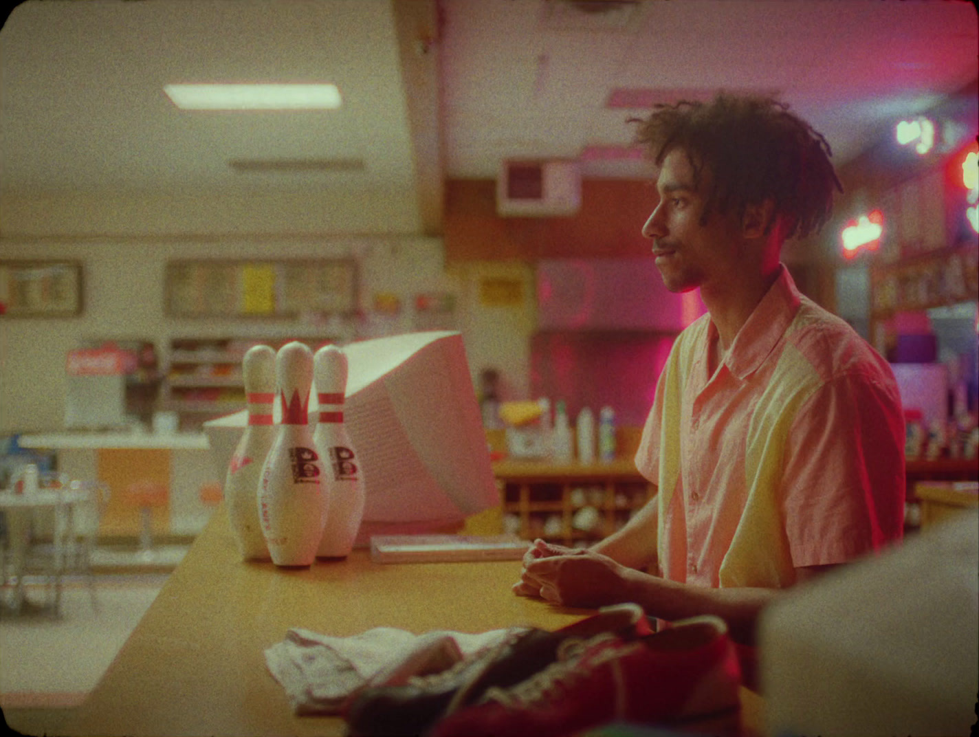 a man sitting at a table with a bowling ball in front of him