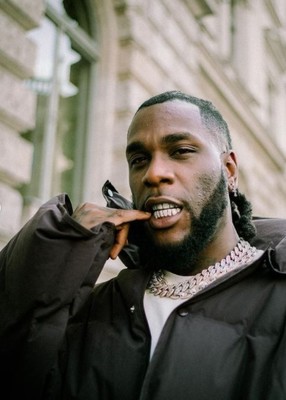 a man talking on a cell phone in front of a building