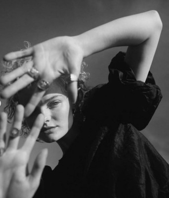 a black and white photo of a woman with her hands on her head